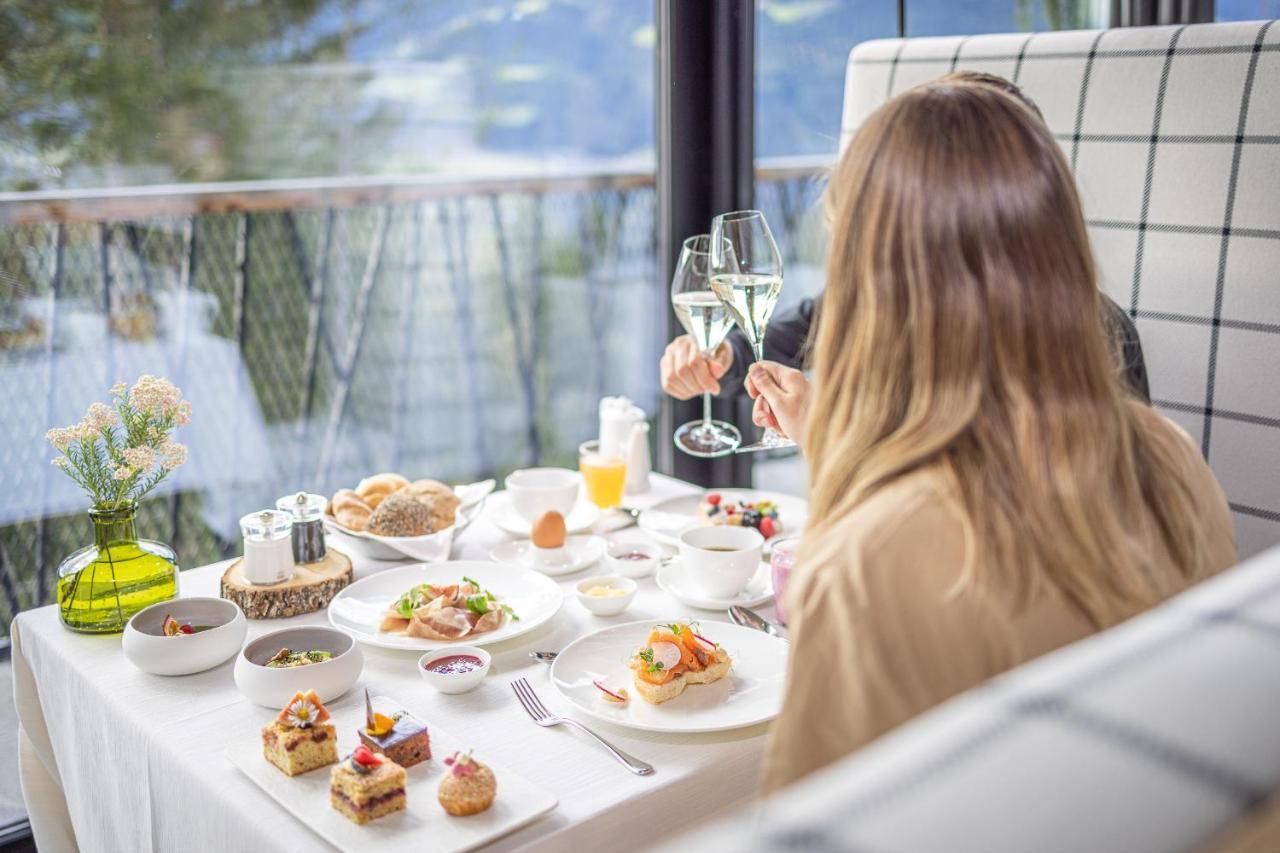 My Arbor - Dolomites Hotel Bressanone Bagian luar foto A woman enjoying a meal at a restaurant